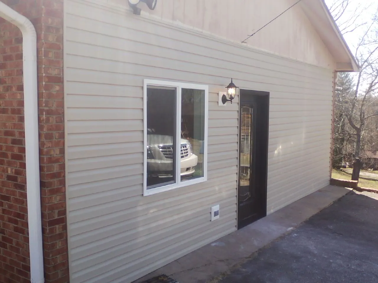 New vinyl siding and entry door on a room addition in Bridgeport